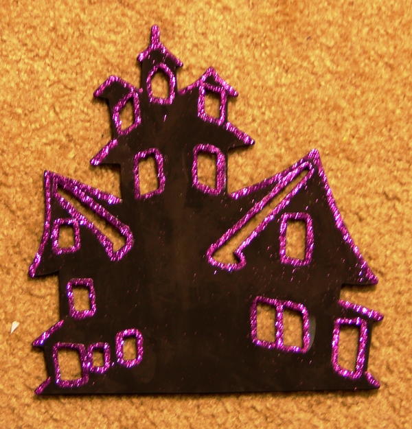 Updating a Halloween decoration.  It had been orange and messy (my daughter's painting when she was little), so I made it black and gave it some purple bling.